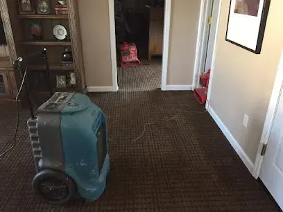 Dehumidifier drying a carpeted hallway after a water loss in Corona, NY